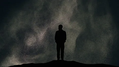 The man standing on a night snowstorm background. slow motion Stock Footage 165353803