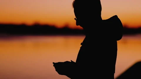 Man standing by the ocean and talking on a smartphone Stock Footage 172249751
