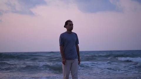 Man standing on ocean coast against big waves Stock Footage 104672005