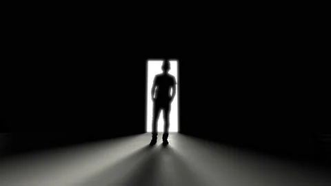 A man standing at an open door in the da... | Stock Video | Pond5