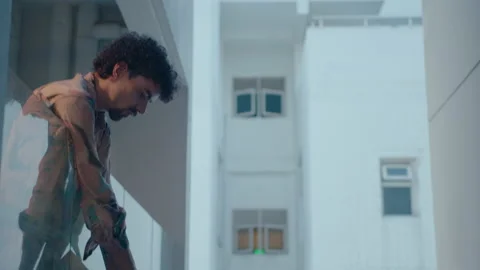 Man Standing Outside on a Balcony Stock Footage 235659547