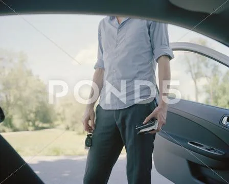 A Man Standing Outside A Car, Midsection