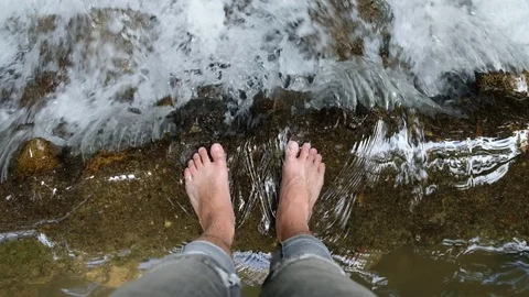 Man standing over river with his feet in the water. slow motion, full hd 1080 Stock Footage 91747168