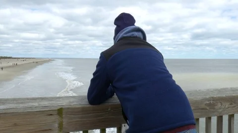 Man standing on peir in the cold Stock Footage 73608985