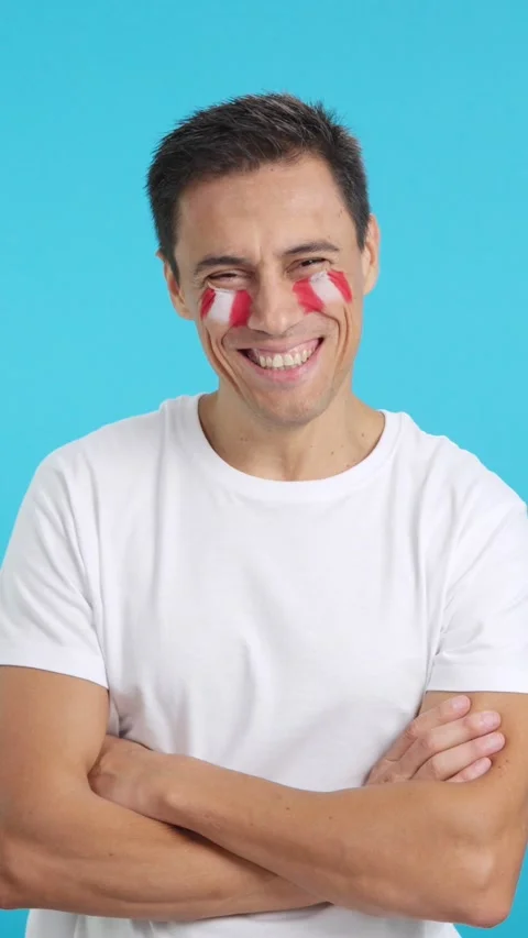 Man standing with peruvian flag painted on face smiling Stock Footage 273969581
