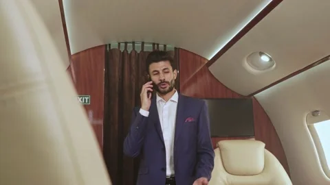 Man standing in the private jet and talking on the phone. Stock-Footage 162823903