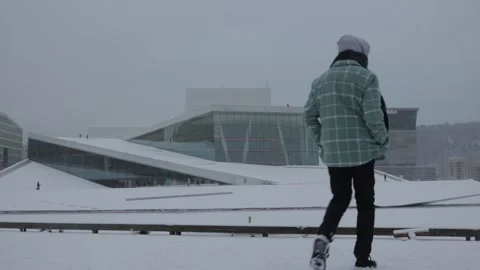 Man Standing in Profile by Oslo Opera House in Winter Snow, Norway Stock Footage 338413637