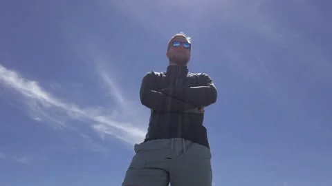 Man standing proudly looking up low angle sky tilt Rockies Kananaskis Vidéo 228559191