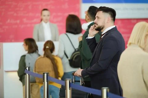 Man standing in a queue Stock Photos