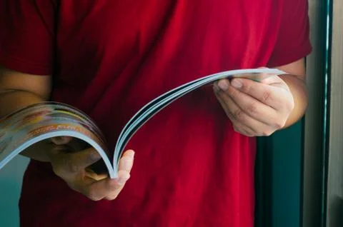 Man standing reading book image focus. Stock Photos