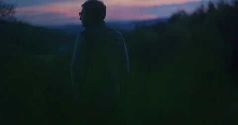 Man standing at red sunset 動画素材 76294411