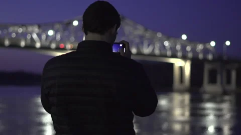 Man Standing by River at Night 库存影片 148127780