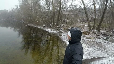 A man standing by the river selfie winter landscape Stock Footage 161077689