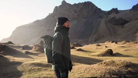 Man standing on rock with epic mountain viewpoint in Iceland Stock Footage 258261860