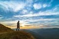 The man standing on the rock with a picturesque sunset Photo