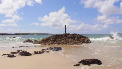 Man Standing on Rocks on the Shore Video stock 69226423