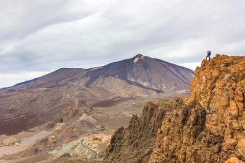 Man standing on rocks with teide volcano on background Stock Photos