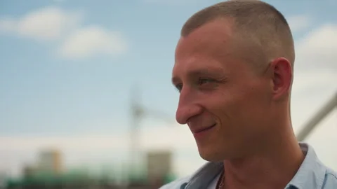 Man standing on rooftop with bright sky and peaceful expression, Male individual Video stock 325213108