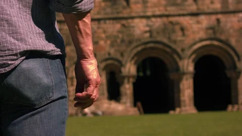Man standing in ruins of old church abbey Stockbeeldmateriaal 337121653