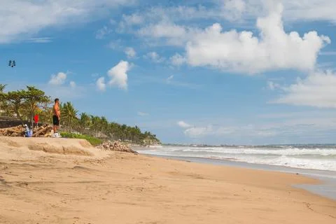 Man Standing on a Sandy Ridge Overlooking the Sea Stock Photos