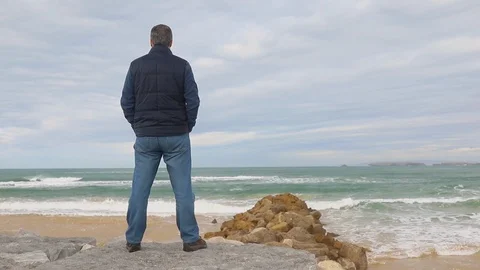 Man standing by the sea at the beach Video stock 104198501