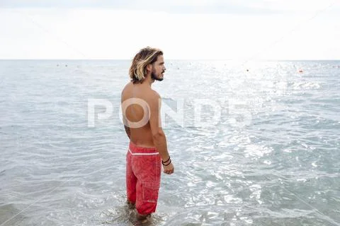 Man standing in sea Stock Photos