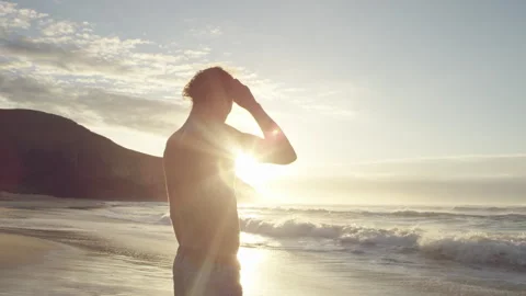 Man standing on the shore watching the waves Stock Footage 279861611