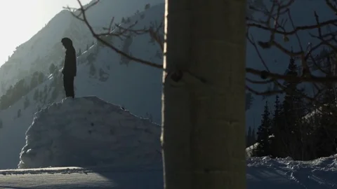 Man standing on the snow cliff during winter Stock Footage 77764903