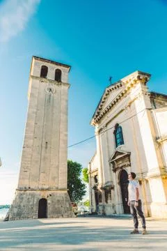 Man standing at square looking at old roman cathedral church in pula city Stock Photos