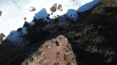 Man Standing on Steep Cliff [Drone Footage] Stock Footage 96232223