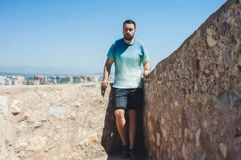 Man standing on a stone wal Stock Photos