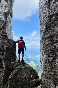 Man standing in stone window, mountain view, blue sky, Bavaria, Germany Stock Photos