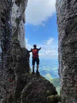 Man standing in stone window, mountain view, blue sky, Bavaria, Germany Stock Photos