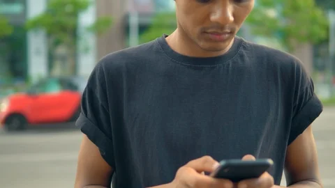 Man standing on the street typing on smartphone Stock Footage 112935358