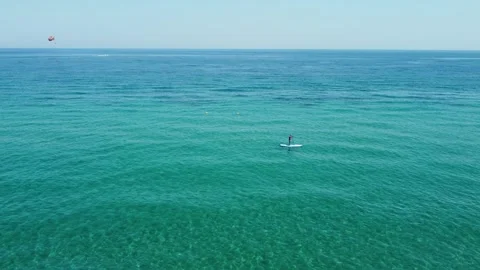 Man Standing On SUP Board While Paddling Stock Footage 247698100