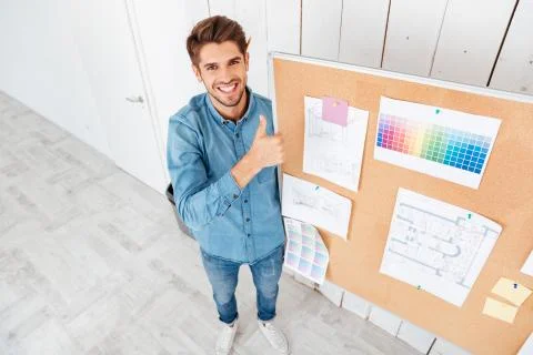 Man standing at task board and showing thumbs up gesture Stock Photos