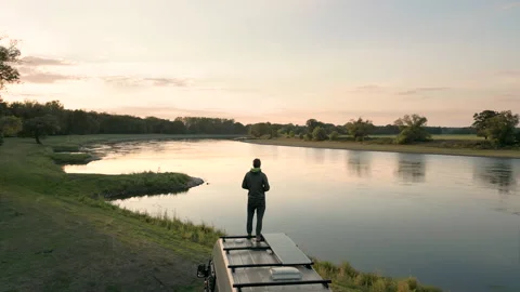 Man standing on top of a camper van in nature Video stock 237682499