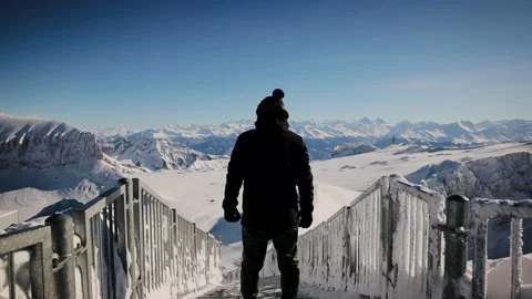 Man standing on the top of Glacier 3000 on Peak Walk bridge, winter mountains Vídeo Stock 224744272