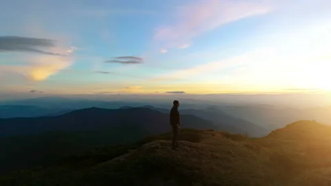 The man standing on the top of the mountain with a beautiful sunrise Stock Footage