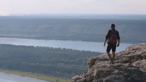 Man standing on top of a mountain with hands raised, Russia . The concept of Video stock 72587404