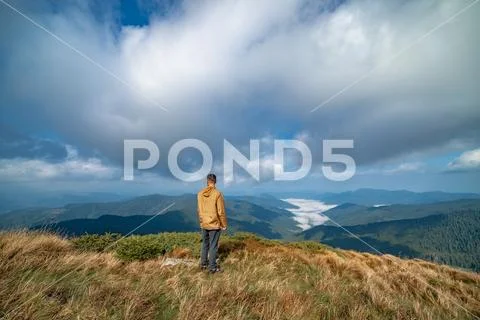 The man standing on the top of a mountain Stock Photos