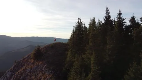 Man Standing On The Top Of The Mountain At Sunset With Forest Background Stock Footage 218477420