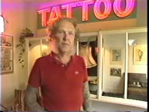 Man Standing Under Neon Tattoo Sign Stock Footage 10849335