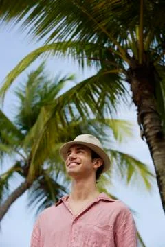 Man standing under palm tree Stock Photos