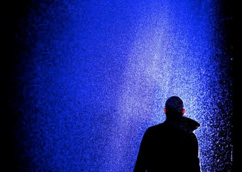 Man standing under rain wet water silhouette Stock Illustration