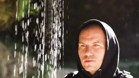 Man standing under waterfall in slow motion Video stock 71567160