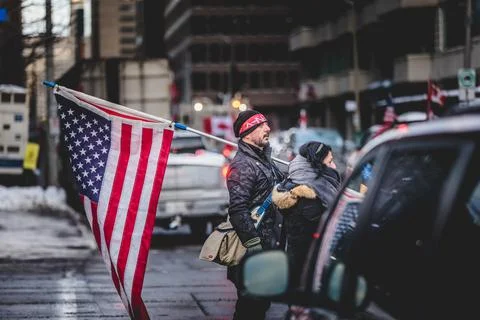 Man Standing with US Flag during the Convoy for Freedom 2022 Trucks and Traco Stock Photos