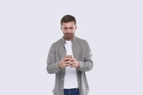 Man Standing Using Phone Isolated. Man Texting on Phone. Technology Stock Photos