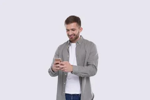 Man Standing Using Phone Isolated. Man Texting on Phone. Technology Stock Photos