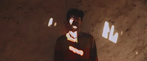 Man standing by the wall looking into camera Stock Footage 202266411